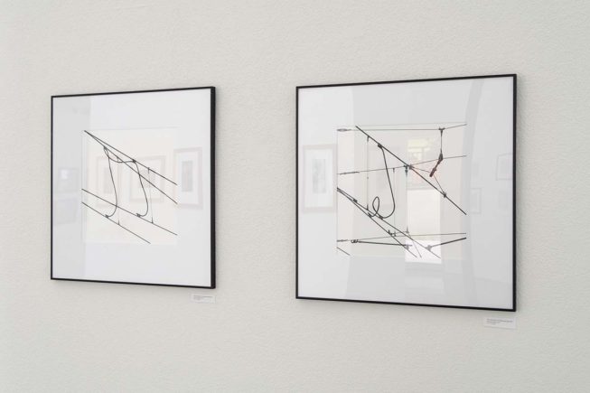 2 photographs hanging on wall