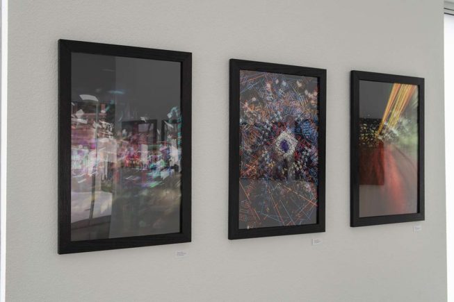3 photographs hanging on wall