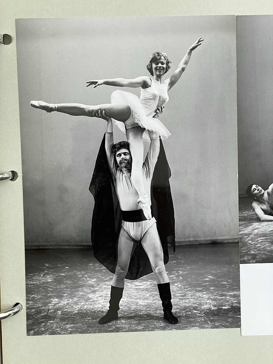 Man holding a ballet dance above his head