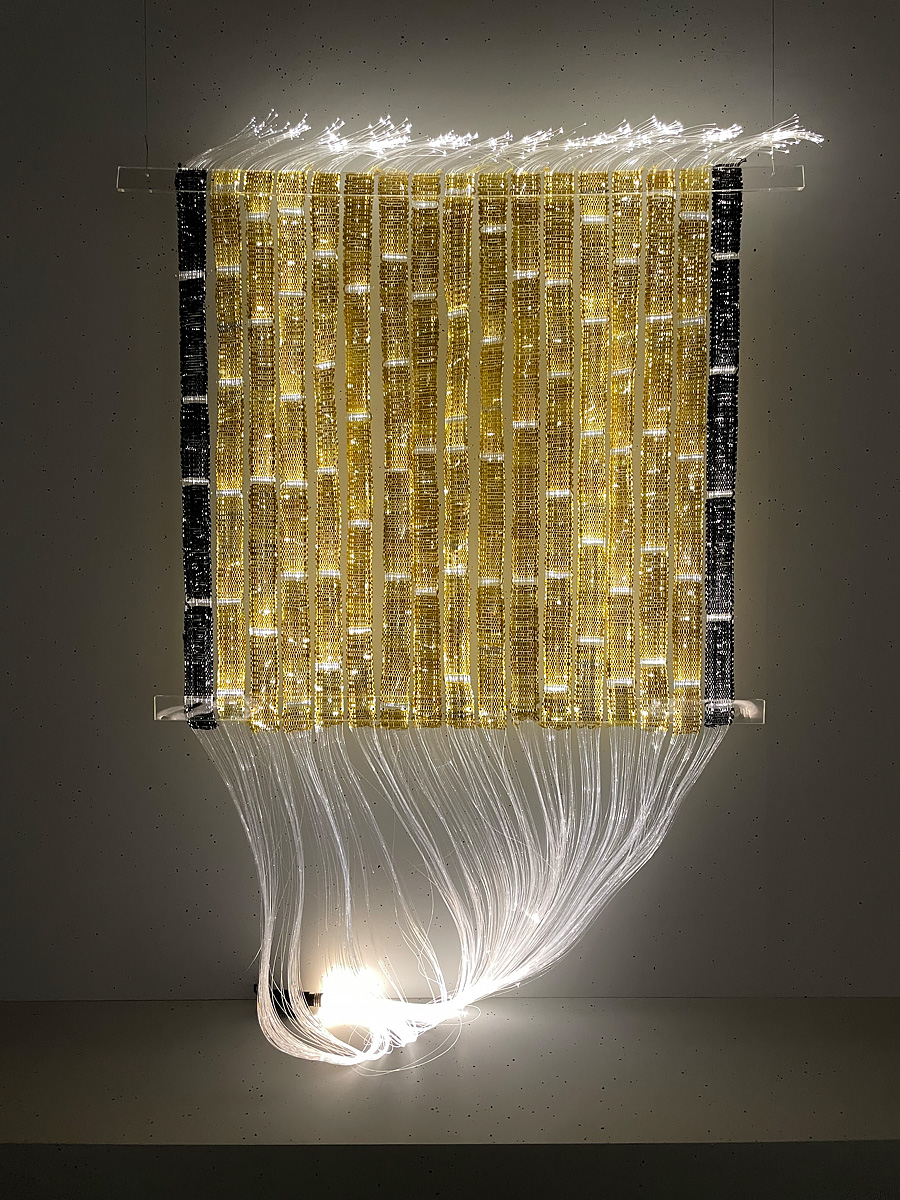 Hanging tapestry made of fiber optic cables